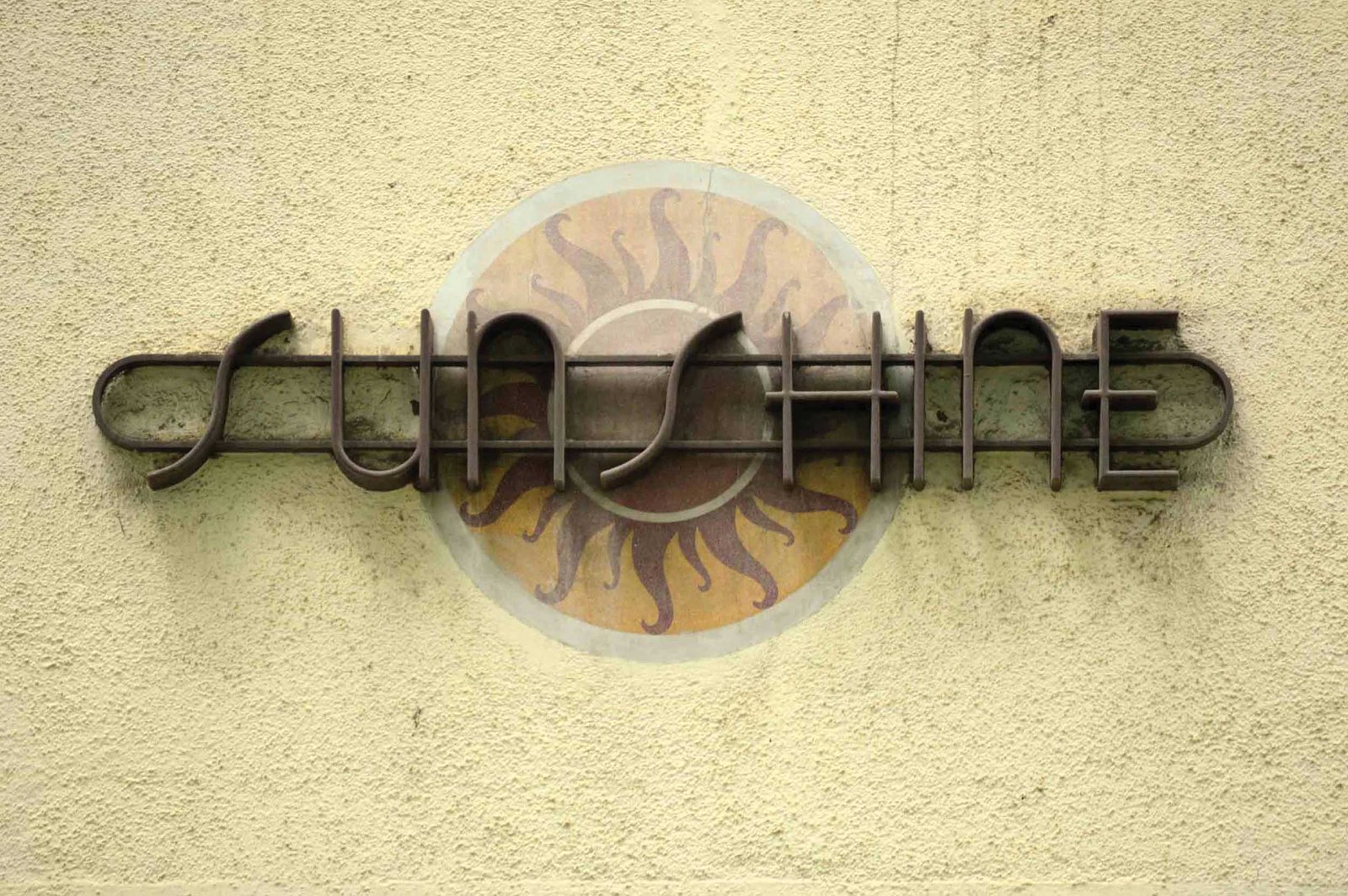 Detailed view of architectural lettering and plaster work on Sunshine, Oval Maidan