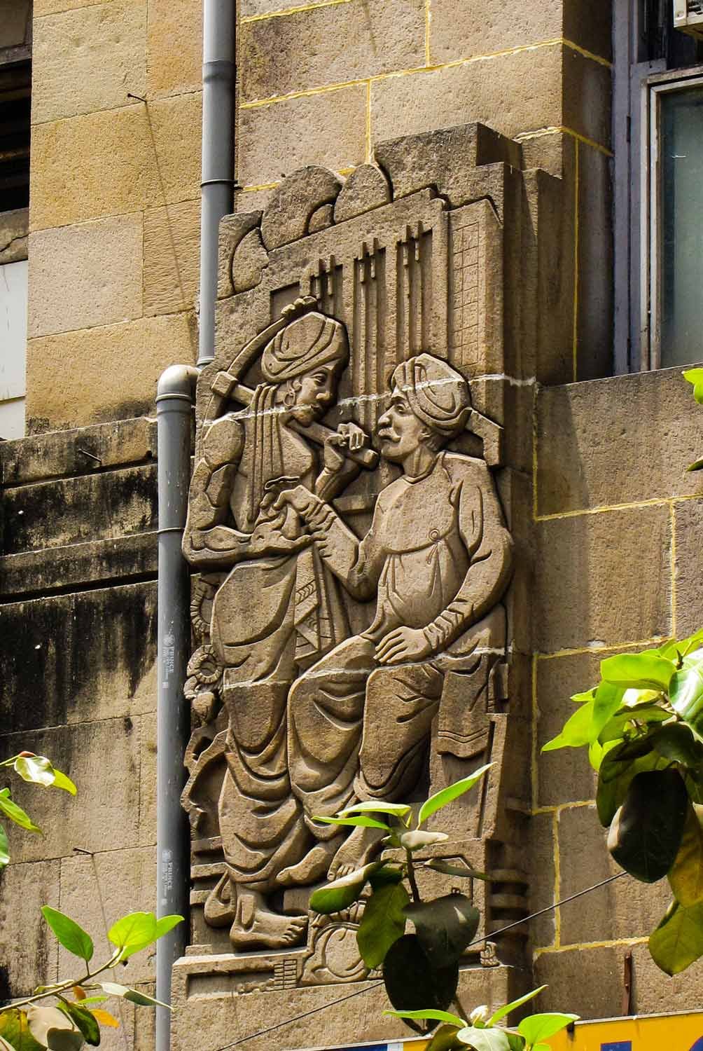 Figure 13: Bas-relief of a moneylender on the façade of the Western India House. Source: Art Deco Mumbai